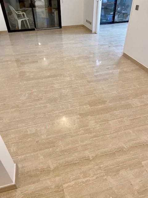 Carrelage grand format effet travertin dans un séjour lumineux